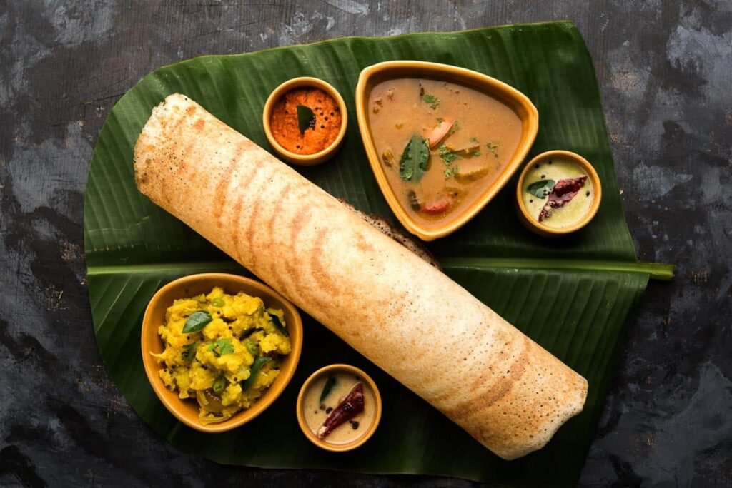 Best Indian street food to try in 2026, featuring popular dishes like pani puri, samosa, vada pav, pav bhaji, and chaat.